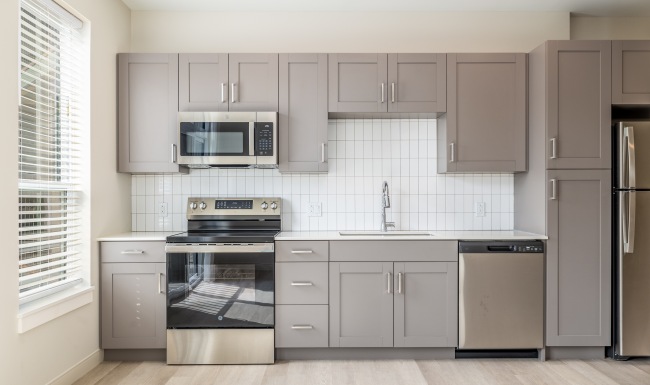 brightly lit kitchen with light gray cabinets